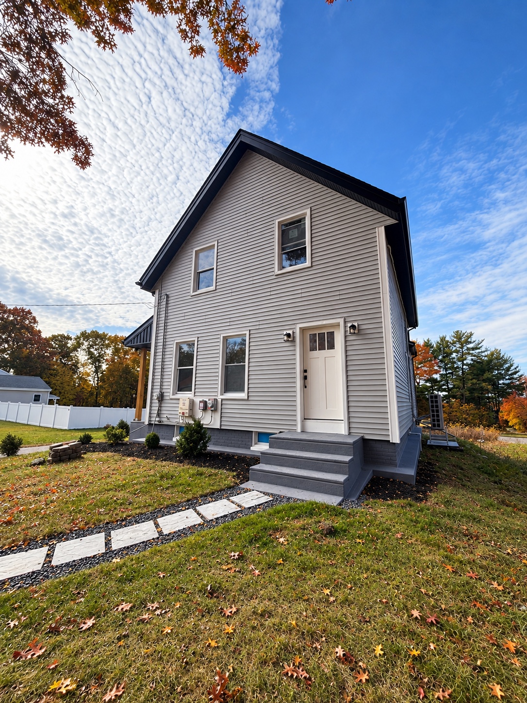 Side entrance and stone paver path of the featured J. Brown Realty listing