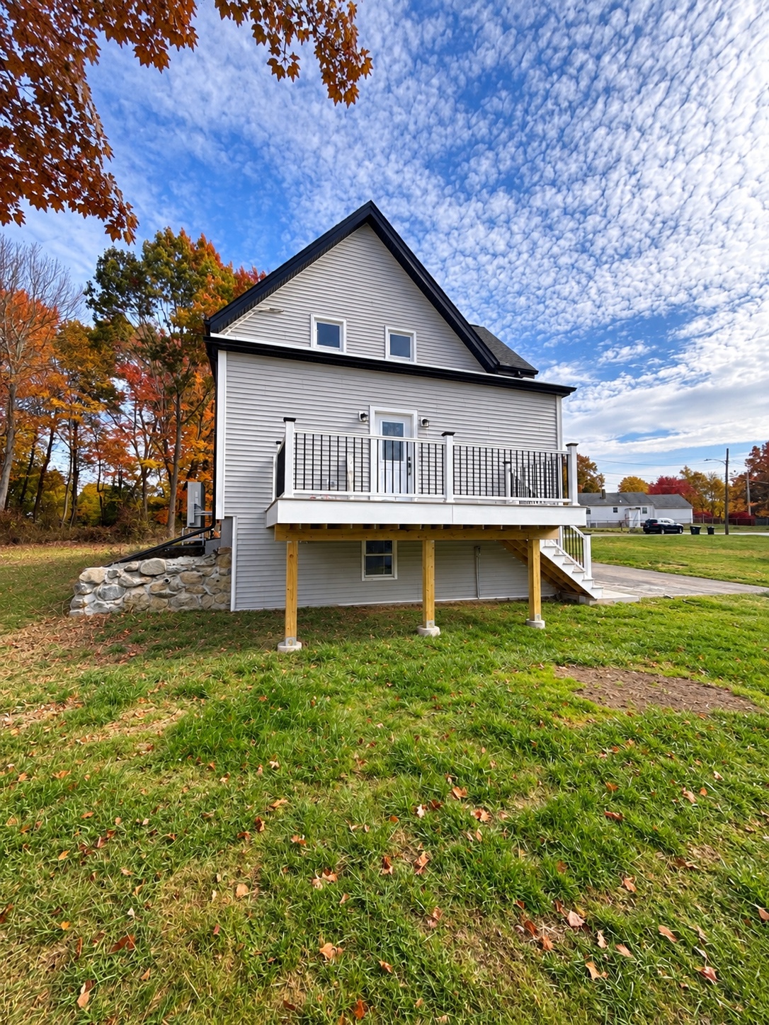 Rear of the featured J. Brown Realty listing with its raised deck